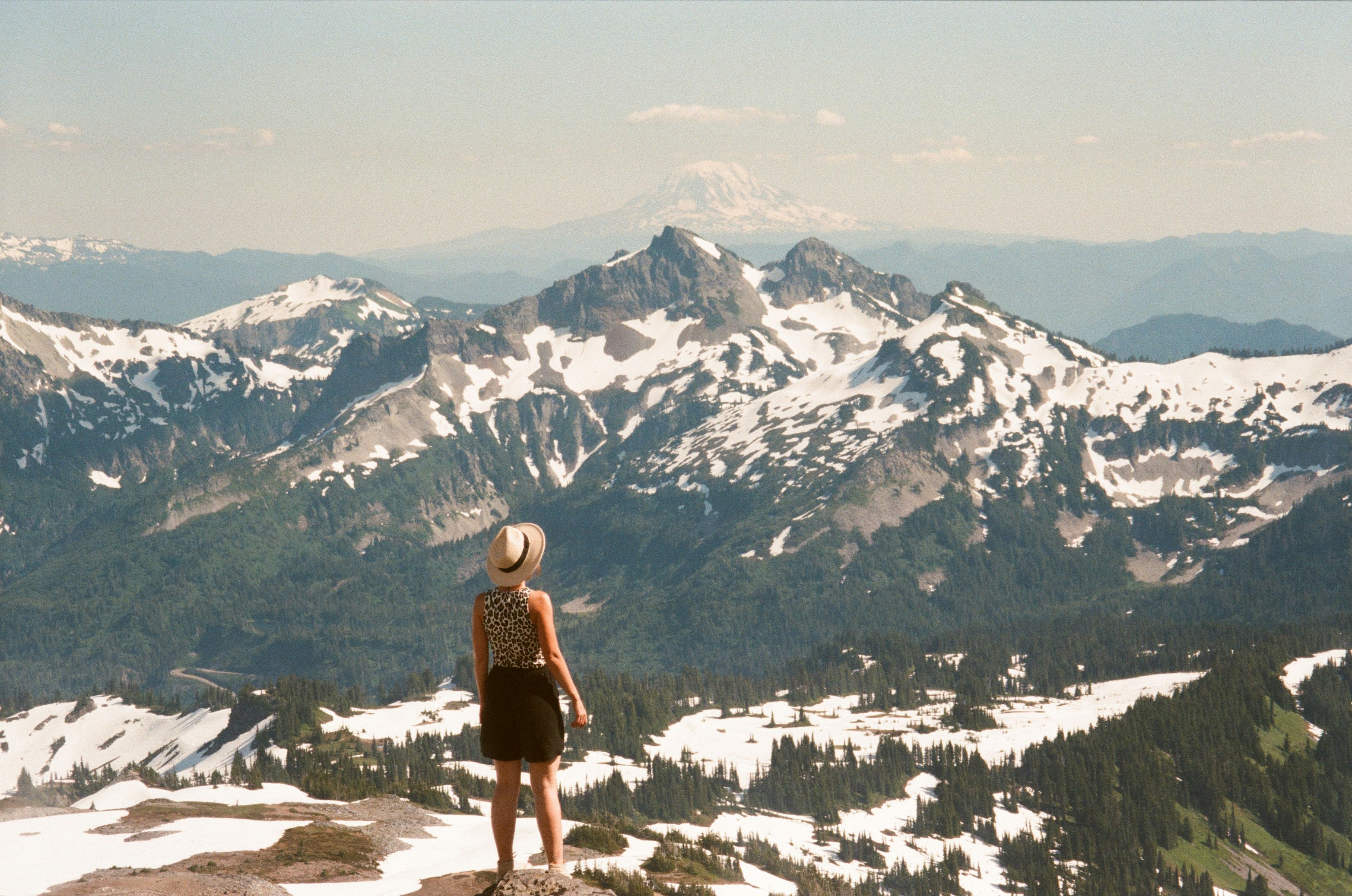 woman in black and white dress standing on snow covered ground during daytime